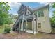 Backyard featuring stairs leading up to a screened-in porch, adding character and functionality to the outdoor space at 223 Falling Water Way, Woodstock, GA 30188