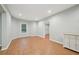 Finished basement features recessed lights, vinyl flooring, and a view to another room at 223 Falling Water Way, Woodstock, GA 30188