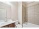 Bathroom features shower-over-tub with tiled surround, vanity sink, and toilet at 223 Falling Water Way, Woodstock, GA 30188