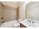 Bathroom features a tub with tile surround, and vanity with a single sink at 223 Falling Water Way, Woodstock, GA 30188