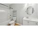 Bright bathroom features a vanity with a white sink, a toilet, and a shower-tub combo at 223 Falling Water Way, Woodstock, GA 30188