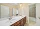 Bright bathroom with double vanity, tiled floors and a walk-in shower at 223 Falling Water Way, Woodstock, GA 30188