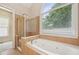 Bathroom features soaking tub and shower at 223 Falling Water Way, Woodstock, GA 30188