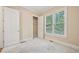 Cozy carpeted bedroom featuring natural light, closet and neutral wall color at 223 Falling Water Way, Woodstock, GA 30188
