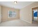 Neutral bedroom features a large window and plush carpeting at 223 Falling Water Way, Woodstock, GA 30188