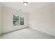 Bedroom with neutral carpet, single window, and overhead light at 223 Falling Water Way, Woodstock, GA 30188