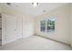Bedroom featuring neutral carpet, a window, and a closet at 223 Falling Water Way, Woodstock, GA 30188