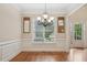 Bright dining room with hardwood floors, large windows, and classic trim at 223 Falling Water Way, Woodstock, GA 30188