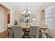 Elegant dining room with a wooden table, chandelier, and stylish decor for sophisticated gatherings at 223 Falling Water Way, Woodstock, GA 30188