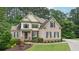 Charming two-story brick home with well-maintained lawn and lovely landscaping features at 223 Falling Water Way, Woodstock, GA 30188