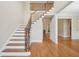 Grand foyer with hardwood floors and staircase with wrought iron spindles at 223 Falling Water Way, Woodstock, GA 30188