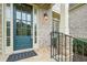 Elegant front door of a brick home, framed by classic stonework and manicured greenery at 223 Falling Water Way, Woodstock, GA 30188