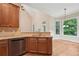 Bright eat-in kitchen features granite countertops, stainless steel appliances and vaulted ceiling at 223 Falling Water Way, Woodstock, GA 30188