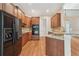 Gourmet kitchen boasts stainless steel appliances, granite countertops, and wood floors at 223 Falling Water Way, Woodstock, GA 30188