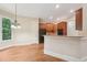 Open kitchen features stainless appliances, granite countertops, and hardwood floors at 223 Falling Water Way, Woodstock, GA 30188