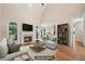 Staged living room featuring fireplace, TV, sofa, and decor creating an inviting atmosphere at 223 Falling Water Way, Woodstock, GA 30188