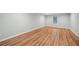 Bright living room features new hardwood flooring and fresh neutral paint at 223 Falling Water Way, Woodstock, GA 30188