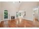 Open-concept living area with fireplace, hardwood floors and large windows at 223 Falling Water Way, Woodstock, GA 30188