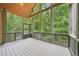 Screened porch with vaulted wood ceiling overlooks the backyard and wooded area at 223 Falling Water Way, Woodstock, GA 30188
