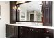 Bathroom with dual sinks, dark cabinets, quartz countertops, and modern fixtures at 3710 Robinson Walk Ct, Marietta, GA 30068
