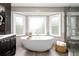 Bright bathroom features a soaking tub near bay windows and a shower with glass doors at 3710 Robinson Walk Ct, Marietta, GA 30068