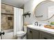 Bright bathroom with tile shower, round mirror, and green vanity with a white countertop at 3710 Robinson Walk Ct, Marietta, GA 30068