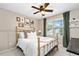 Bedroom with a gold-colored bed frame, neutral walls, bright window, and decorative art pieces for a warm feel at 3710 Robinson Walk Ct, Marietta, GA 30068