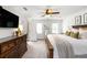 Bright main bedroom with a ceiling fan, TV, large dresser, and a neutral color palette at 3710 Robinson Walk Ct, Marietta, GA 30068