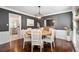View of the dining room with a wooden table, chandelier and dark gray walls at 3710 Robinson Walk Ct, Marietta, GA 30068