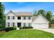 Charming white two-story home with a well-manicured lawn and a two-car garage at 3710 Robinson Walk Ct, Marietta, GA 30068