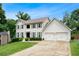 Beautiful white two-story home with attached garage and well manicured lawn at 3710 Robinson Walk Ct, Marietta, GA 30068