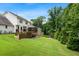 A tiered backyard featuring a well-manicured lawn, landscaping, and a deck at 3710 Robinson Walk Ct, Marietta, GA 30068