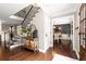 Stunning foyer showcasing wood floors, stairs, and a view into the dining room at 3710 Robinson Walk Ct, Marietta, GA 30068