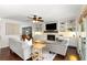 A bright and airy living room with a fireplace, built-in shelves, and hardwood floors at 3710 Robinson Walk Ct, Marietta, GA 30068