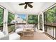 Inviting screened porch with comfortable seating, ceiling fan, and views of the surrounding greenery at 3710 Robinson Walk Ct, Marietta, GA 30068