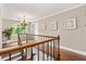Upstairs hallway with hardwood floors, a light fixture and three art pieces on the wall at 3710 Robinson Walk Ct, Marietta, GA 30068