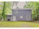 The backyard features a chain link fence, grass, and trees at 5352 Windfern Ct, Stone Mountain, GA 30088