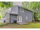 The backyard has a patio, grass and shade trees at 5352 Windfern Ct, Stone Mountain, GA 30088