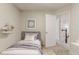 A staged bedroom with a bed, decor and a view of the stairs at 5352 Windfern Ct, Stone Mountain, GA 30088