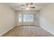 Empty bedroom featuring a bay window, neutral walls, carpet floors, and ceiling fan at 5352 Windfern Ct, Stone Mountain, GA 30088