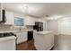 Bright kitchen features sleek, white cabinets, stainless steel appliances, and a center island at 5352 Windfern Ct, Stone Mountain, GA 30088