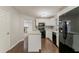 Modern kitchen boasts white cabinets, black appliances, and a functional center island at 5352 Windfern Ct, Stone Mountain, GA 30088