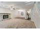 Inviting living room featuring a stone fireplace, plush carpet, and open layout at 5352 Windfern Ct, Stone Mountain, GA 30088