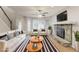 Stylishly staged living room with a stone fireplace and abundant natural light at 5352 Windfern Ct, Stone Mountain, GA 30088