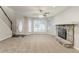 Comfortable living room with a stone fireplace and plenty of natural light coming from the large bay window at 5352 Windfern Ct, Stone Mountain, GA 30088