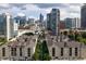 Overhead view of an apartment community with a city skyline in the background at 1075 Peachtree Walk # A-307, Atlanta, GA 30309