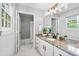 Bright bathroom featuring granite counters, white cabinets, and a shower-tub combination at 1075 Peachtree Walk # A-307, Atlanta, GA 30309