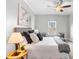 Bedroom with a bed and side table. Has a ceiling fan and a view through a single window at 1075 Peachtree Walk # A-307, Atlanta, GA 30309