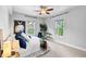 Bedroom boasts city views from two windows and modern décor including a plant and blue pillows at 1075 Peachtree Walk # A-307, Atlanta, GA 30309