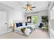 Bedroom boasts city views from two windows and modern décor including a plant and blue pillows at 1075 Peachtree Walk # A-307, Atlanta, GA 30309